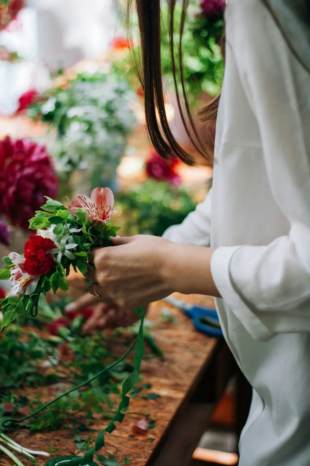 A florist arranging stems