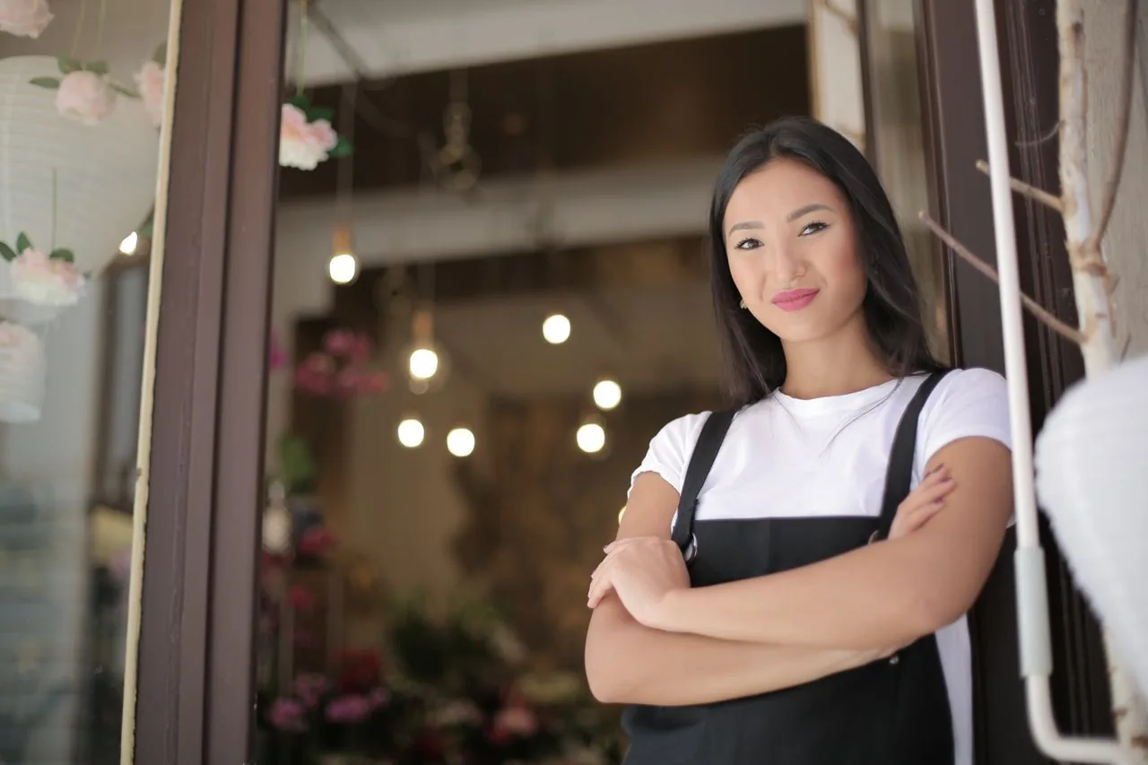 A confident florist and shop owner in her studio